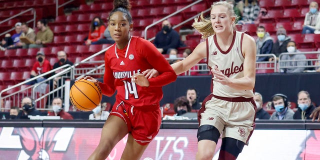 Louisville guard Kianna Smith (14) drives the ball up the court as Boston College guard Cameron Swartz (1) defends during the first half of an NCAA college basketball game, Sunday, Jan. 16, 2022, in Boston.