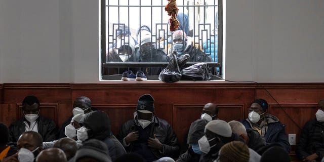 People look through window during the funeral service for victims of a deadly apartment  fire, at Islamic Cultural Center for the Bronx on Sunday, Jan. 16, 2022, in New York. 