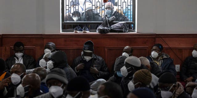 People look through window during the funeral service for victims of a deadly apartment  fire, at Islamic Cultural Center for the Bronx on Sunday, Jan. 16, 2022, in New York. 