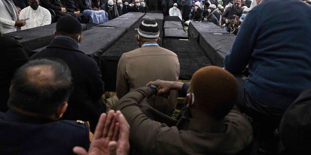 A person prays during the funeral service for victims from the apartment building which suffered the city's deadliest fire in three decades, at the Islamic Cultural Center for the Bronx on Sunday, Jan. 16, 2022, in New York.  