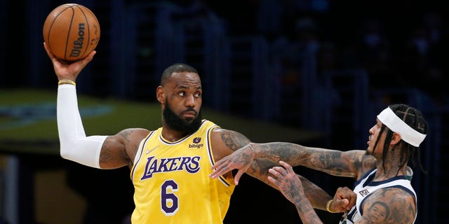 Los Angeles Lakers forward LeBron James (6) is defended by Utah Jazz guard Jordan Clarkson, right, during the first half in Los Angeles on Jan. 17, 2022.