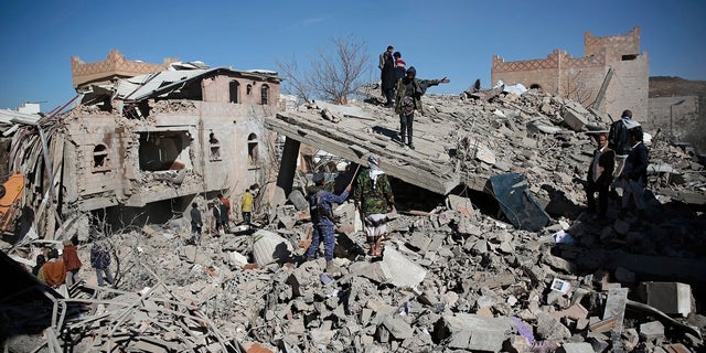 Yemenis inspect the wreckage of buildings after they were hit by Saudi-led coalition airstrikes, in Sanaa, Yemen, Tuesday, Jan. 18, 2022. (AP Photo/Hani Mohammed)