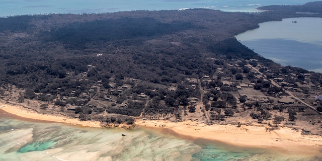 In this photo provided by the New Zealand Defense Force, volcanic ash covers rooftops and vegetation in an area of Tonga, Monday, Jan. 17, 2022. (CPL Vanessa Parker/NZDF via AP, File)