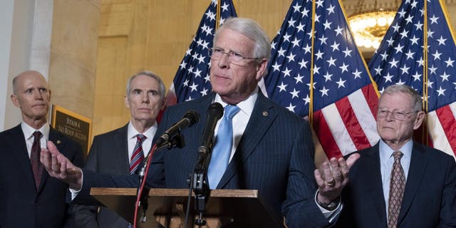 Sen. Roger Wicker, R-Miss., center, accompanied by Sen. Rick Scott, R-Fla., Sen. Rob Portman, R-Ohio, and Sen. Jim Inhofe, R-Okla. ( AP Photo/Jose Luis Magana)