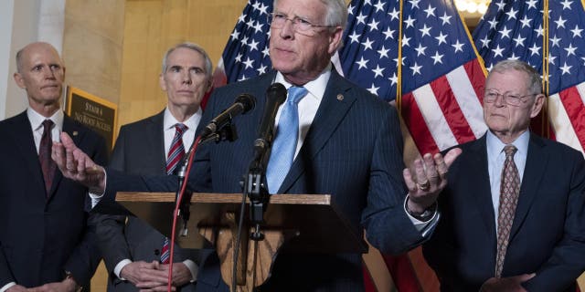 Sen. Roger Wicker, R-Miss., center, accompanied by Sen. Rick Scott, R-Fla., Sen. Rob Portman, R-Ohio, and Sen. Jim Inhofe, R-Okla. ( AP Photo/Jose Luis Magana)