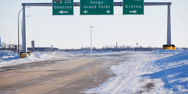 Road signage is posted just outside of Emerson, Manitoba on Thursday, Jan. 20, 2022.