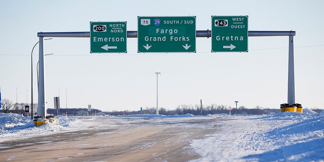 Road signs were posted outside Emerson, Manitoba, Canada on Thursday, January 20, 2022. 