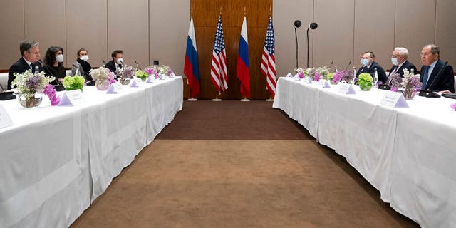 Secretary of State Antony Blinken, left, listens as Russian Foreign Minister Sergey Lavrov speaks, Friday, Jan. 21, 2022, in Geneva, Switzerland. (AP Photo/Alex Brandon, Pool)