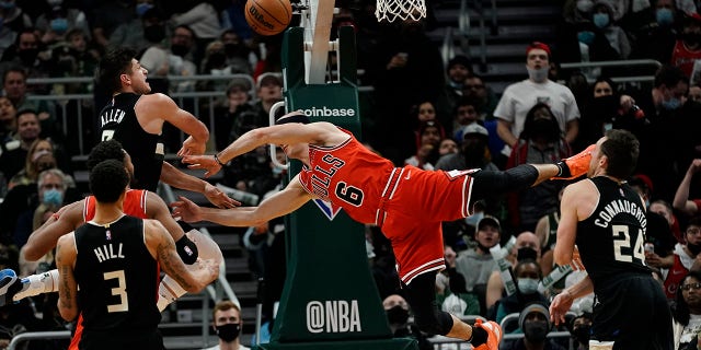 Milwaukee Bucks' Grayson Allen fouls Chicago Bulls' Alex Caruso during the second half of an NBA basketball game Friday, Jan. 21, 2022, in Milwaukee. The Bucks won 94-90.