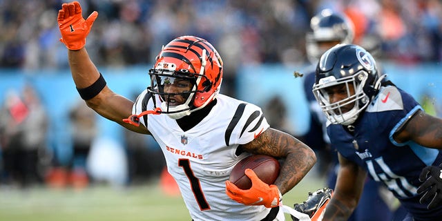 Cincinnati Bengals wide receiver Ja'Marr Chase (1) takes on the Tennessee Titans in the first half of an NFL Divisional Round playoff football game Saturday, Jan. 22, 2022, in Nashville, Tennessee.