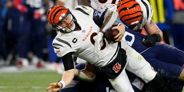 Titans Anthony Rush and Harold Landry sack Cincinnati Bengals quarterback Joe Burrow Saturday, Jan. 22, 2022, in Nashville, Tennessee.