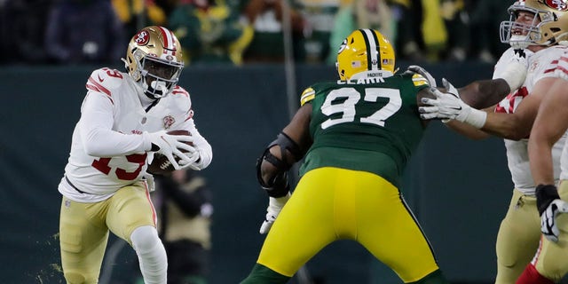 San Francisco 49ers' Deebo Samuel tries to get past Green Bay Packers' Kenny Clark during the first half of an NFC divisional playoff NFL football game Saturday, Jan. 22, 2022, a Green Bay, Wis. 