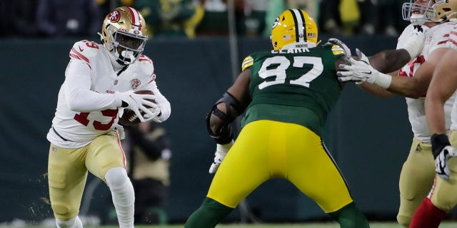San Francisco 49ers' Deebo Samuel tries to get past Green Bay Packers' Kenny Clark during the first half of an NFC divisional playoff NFL football game Saturday, Jan. 22, 2022, a Green Bay, Wis.