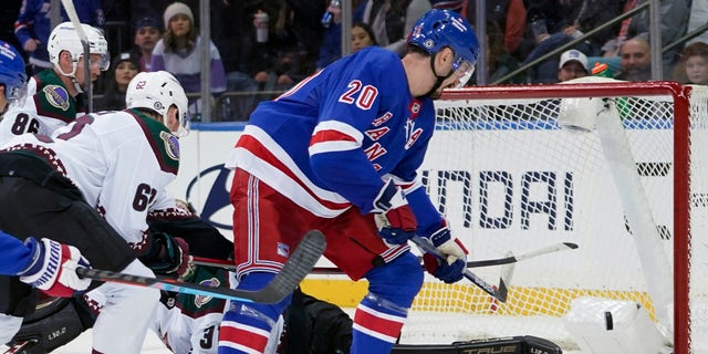 New York Rangers left wing Chris Kreider (20) scores his third goal of the night, past Arizona Coyotes goaltender Scott Wedgewood (31) during the third period of an NHL hockey game Saturday, Jan. 22, 2022, at Madison Square Garden in New York. The Rangers won 7-3. 