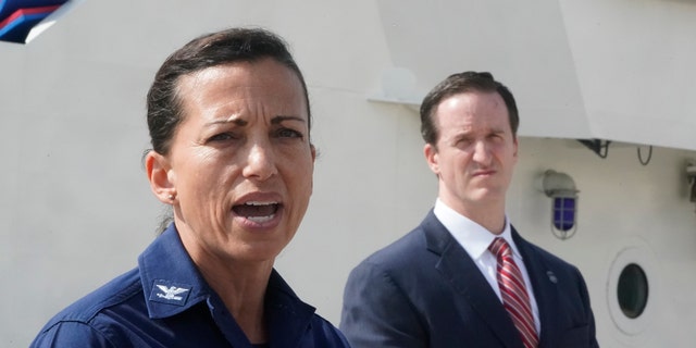 U.S. Coast Guard Capt. Jo-Ann Burdian, foreground, speaks along with Homeland Security Investigations Special Agent in Charge in Miami Anthony Salisbury, rear, during a news conference, Thursday, Jan. 27, 2022, at Coast Guard Sector Miami in Miami Beach, Florida. 