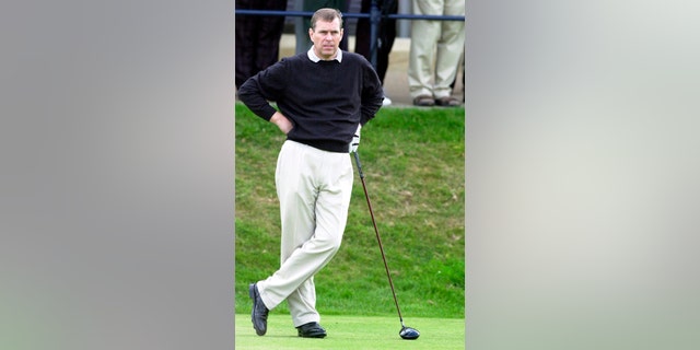 In this image, Andrew waits to play a shot at the Royal and Ancient Golf club in St Andrews, Fife, after assuming the position of captain of the club, on Sept. 18, 2003. 