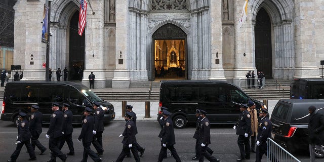 New York Police officers gather for the funeral of Officer Jason Rivera, Friday, Jan. 28, 2022, outside St. Patrick's Cathedral in New York. (AP Photo/Yuki Iwamura)