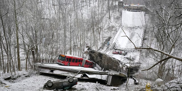 A Port Authority bus that was on a bridge when it collapsed is visible in Pittsburgh's East End. (AP Photo/Gene J. Puskar)