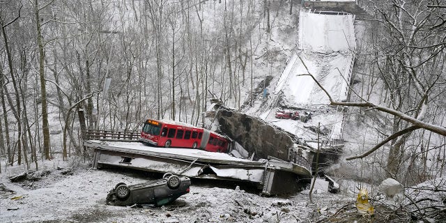 A Port Authority bus that was on a bridge when it collapsed is visible in Pittsburgh's East End. (AP Photo/Gene J. Puskar)