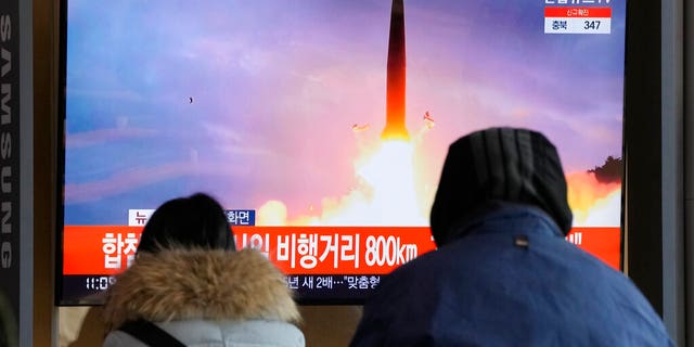People watch a TV showing a file image of North Korea's missile launch during a news program showing at the Seoul Railway Station in Seoul, South Korea, Sunday, Jan. 30, 2022. (AP Photo/Ahn Young-joon)