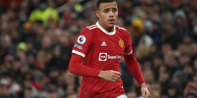 FILE- Manchester United's Mason Greenwood runs during the English Premier League soccer match between Manchester United and Burnley at Old Trafford in Manchester, England, Thursday, Dec. 30, 2021. Manchester United says forward Mason Greenwood will not play or practice with the club until further notice after being accused of sexual assault by a woman, with police also looking into the incident. The statement from the Premier League club was issued on Sunday, Jan. 30, 2022 in response to allegations being posted within videos, photographs and an audio recording that are no longer visible on a woman’s Instagram account.