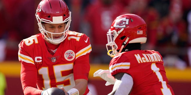 Kansas City Chiefs quarterback Patrick Mahomes (15) hands the ball off to running back Jerick McKinnon (1) during the first half of the AFC championship NFL football game against the Cincinnati Bengals, Sunday, Jan. 30, 2022, in Kansas City, Mo.