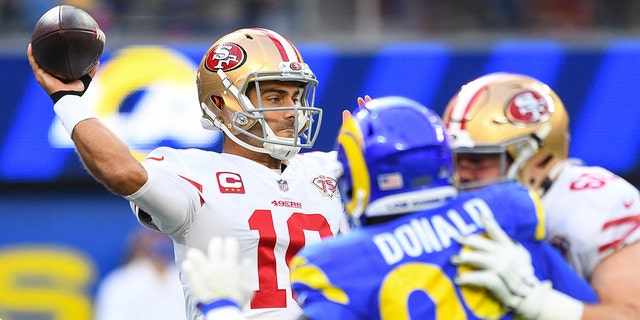 San Francisco 49ers Quarterback Jimmy Garoppolo (10) throws a pass under pressure from Los Angeles Rams Defensive Tackle Aaron Donald (99) during the NFL game between the San Francisco 49ers and the Los Angeles Rams on January 9, 2022, at SoFi Stadium in Inglewood, QUE.