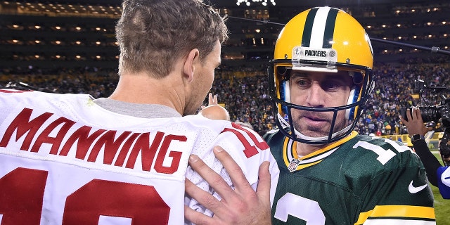 Aaron Rodgers of the Green Bay Packers speaks with Eli Manning of the New York Giants following a game at Lambeau Field on Oct. 9, 2016 in Green Bay, Wisconsin.