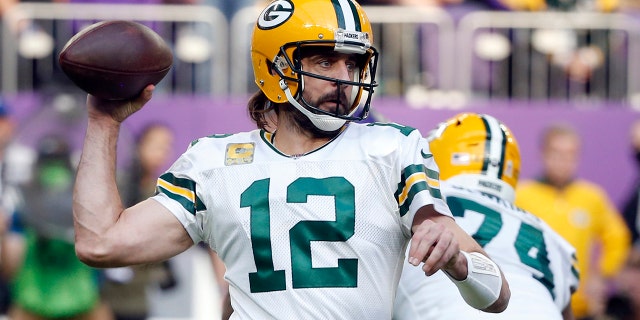 Green Bay Packers quarterback Aaron Rodgers (12) throws a pass during the first half of an NFL football game against the Minnesota Vikings, on Nov. 21, 2021, in Minneapolis.