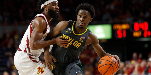 Iowa State guard Tre Jackson (3) fouls Baylor guard Adam Flagler (10) during the second half of an NCAA college basketball game, Saturday, Jan. 1, 2022, in Ames, Iowa. Baylor won 77-72.