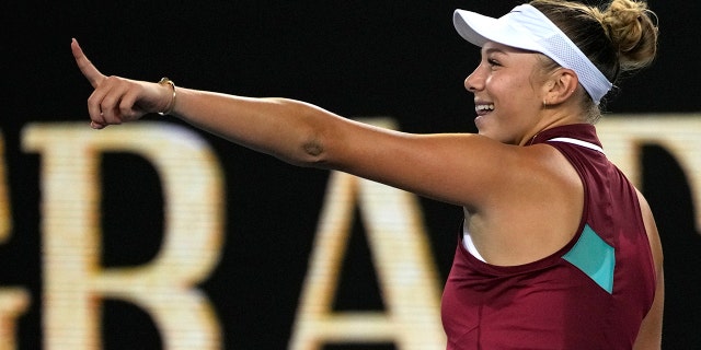 Amanda Anisimova of the U.S. celebrates after defeating Naomi Osaka of Japan in their third-round match at the Australian Open tennis championships in Melbourne, Australia, Friday, Jan. 21, 2022.