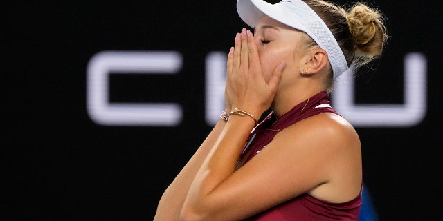 Amanda Anisimova of the U.S. celebrates after defeating Naomi Osaka of Japan in their third-round match at the Australian Open tennis championships in Melbourne, Australia, Friday, Jan. 21, 2022.