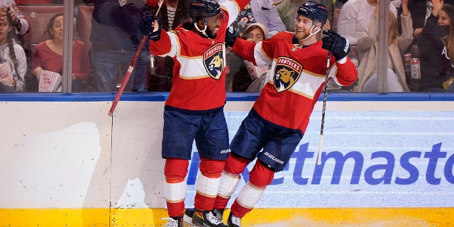 Florida Panthers left wing Anthony Duclair, left, helps center Sam Bennett celebrate his goal during the second period of an NHL hockey game against the Dallas Stars, Friday, Jan. 14, 2022, in Sunrise, Fla.