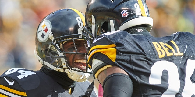 Pittsburgh Steelers wide receiver Antonio Brown celebrates with running back Le'Veon Bell after making a 62-yard touchdown in the first quarter during a NFL AFC Wild Card football game between the Pittsburgh Steelers and the Miami Dolphins on Jan. 8, 2017 at Heinz Field in Pittsburgh, Pennsylvania.