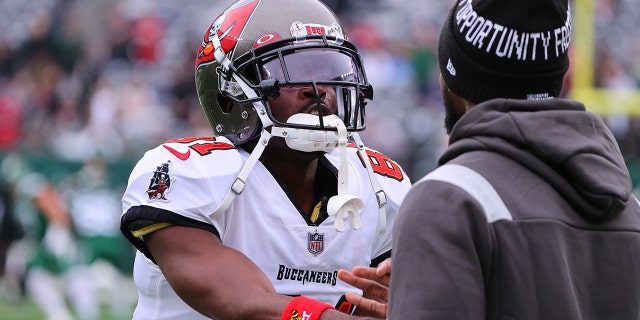 Tampa Bay Buccaneers wide receiver Antonio Brown talks with a teammate prior to the National Football League game between the New York Jets and the Tampa Bay Buccaneers on Jan. 2, 2022, at MetLife Stadium in East Rutherford, New Jersey.