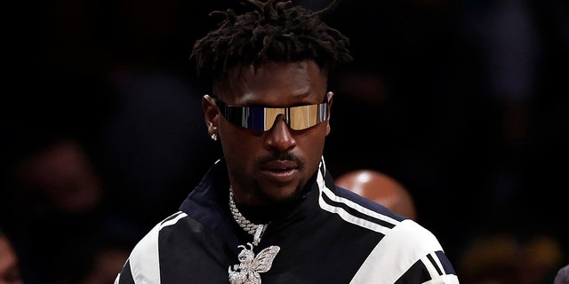 Former Tampa Bay Buccaneers wide receiver Antonio Brown comes onto the court during the second half of an NBA basketball game between the Memphis Grizzlies and Brooklyn Nets January 3, 2022 in New York.