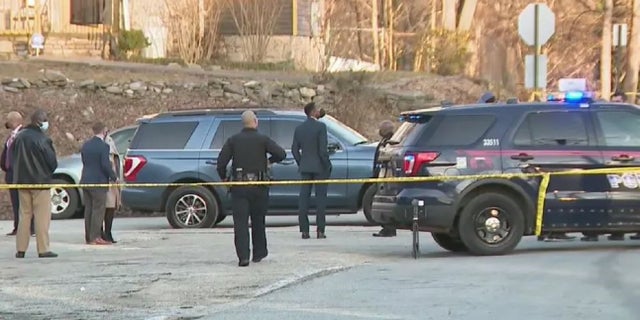Atlanta investigators at the scene where a 6-month-old child was killed Monday. The child was the second to be killed and third to be shot this year.