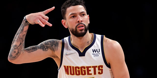 Denver Nuggets guard Austin Rivers reacts after making a 3-point basket against the Brooklyn Nets during the second half of an NBA basketball game Wednesday, Jan. 26, 2022, in New York. The Nuggets won 124-118.