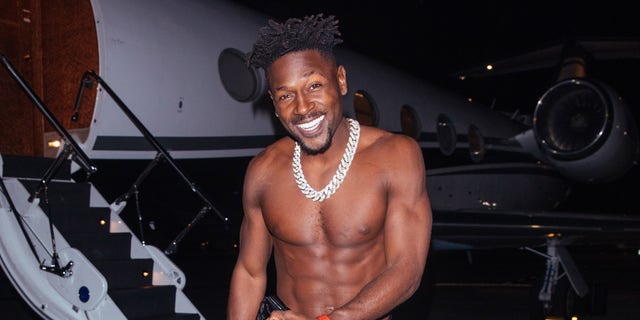 A shirtless Antonio Brown steps off his private jet to meet Kanye West for dinner in West Hollywood.