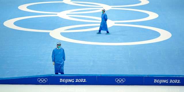 Medical personnel stand ready for activity during a scheduled speedskating practice session inside at the National Speed Skating Oval the 2022 Winter Olympics, Thursday, Jan. 27, 2022, in Beijing.