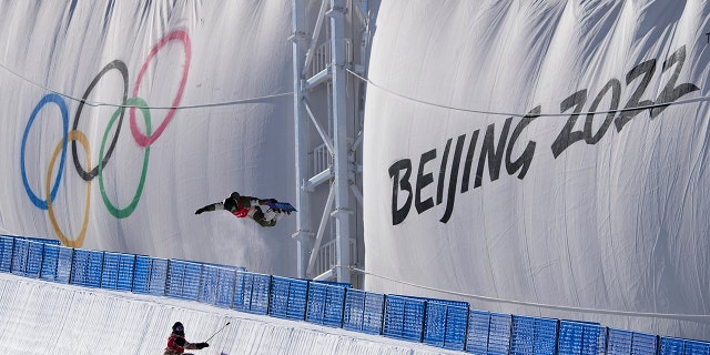 A snowboarder catches air while training on the half pipe ahead of the 2022 Winter Olympics, Thursday, Jan. 27, 2022, in Zhangjiakou, China.