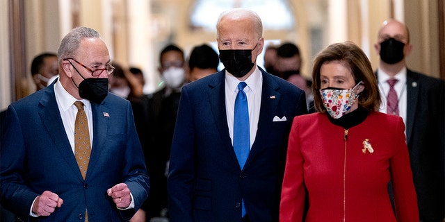 President Biden walks with Senate Majority Leader Chuck Schumer of N.Y., left, and House Speaker Nancy Pelosi of Calif., right, as he arrives at the U.S. Capitol to mark one year since the Jan. 6 riot at the Capitol by supporters loyal to then-President Donald Trump, Thursday, Jan. 6, 2022, in Washington. 