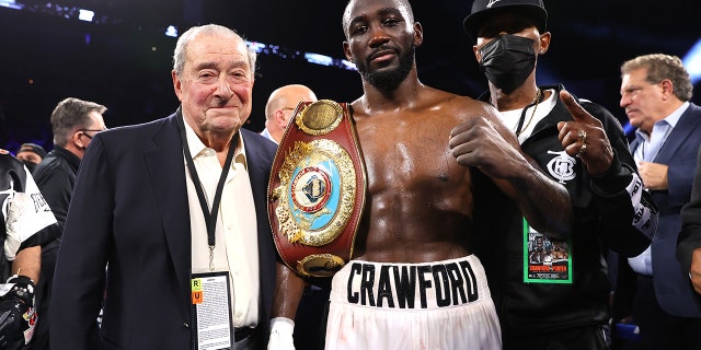 Bob Arum (L) and Terence Crawford (R) victory pose as he defeats Shawn Porter for the WBO welterweight championship at Michelob ULTRA Arena on November 20, 2021 in Las Vegas, Nevada.
