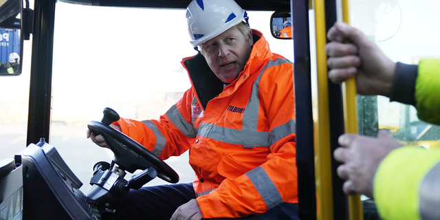 British Prime Minister Boris Johnson drives a forklift as he visits the Tilbury Docks in Tilbury, England, on Monday.