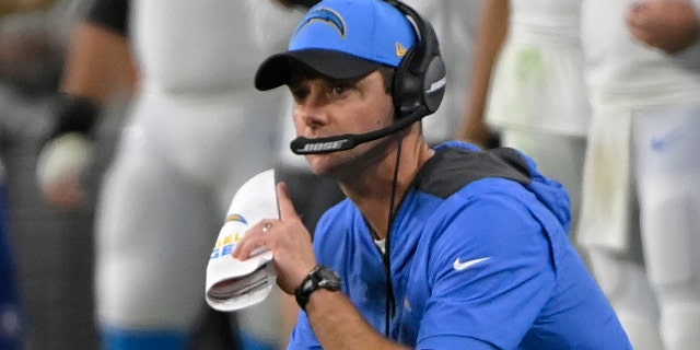 Los Angeles Chargers head coach Brandon Staley kneels on the sideline during the second half of an NFL football game against the Las Vegas Raiders, Sunday, Jan. 9, 2022, in Las Vegas.