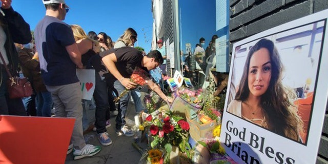 Flowers flood the sidewalk in front of the Croft House, where Brianna Kupfer was killed on Jan. 13. 