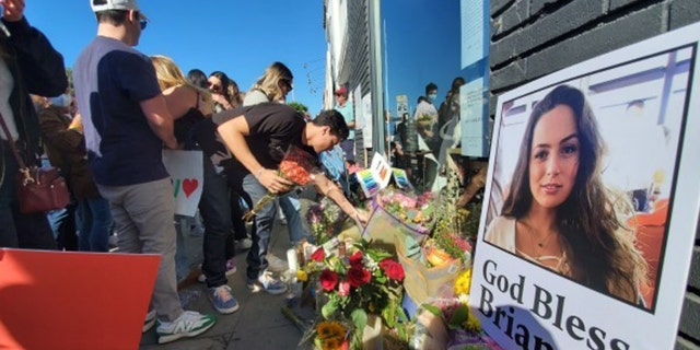 Flowers flood the sidewalk in front of the Croft House, where Brianna Kupfer was killed on Jan. 13.