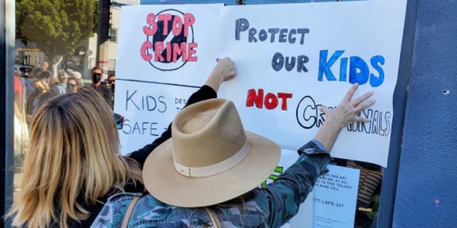 Several people brought homemade signs demanding tougher penalties for criminals. 