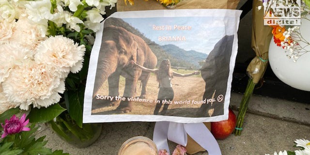 A memorial consisting of flowers and images of Brianna Kupfer is seen outside the Croft House furniture shop in Los Angeles. 