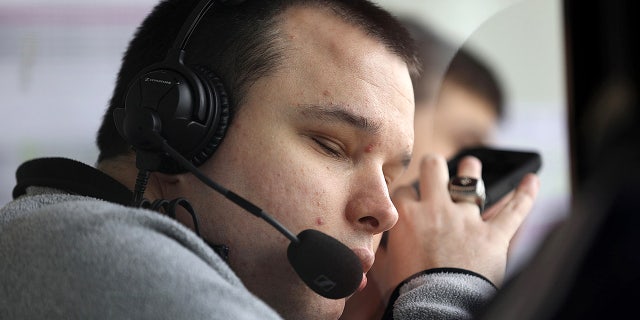 Bryce Weiler, a blind sports commentator, brings his phone closer to his ear while announcing a few innings for Georgia Tech during a game against the University of Illinois at Chicago at the Curtis Granderson Stadium in Chicago on April 28, 2017.
